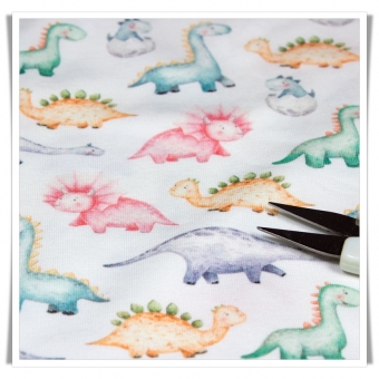 Tela de camiseta estampada con dibujos de dinosaurios en tonos pastel